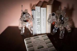 a book sitting on top of a table with books at La Canonica Di Nusenna in Gaiole in Chianti