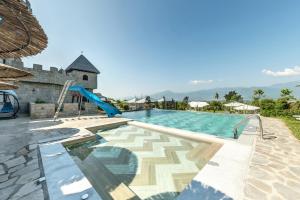 a swimming pool with a slide and a playground at Royal Valentina Castle in Ognyanovo