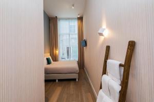 a small room with a bed and a window at Stadsvilla Mout Rotterdam-Schiedam in Schiedam +28 photos