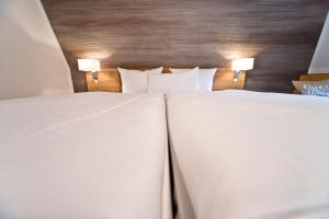 Postel nebo postele na pokoji v ubytování C-YOU Hotel Chemnitz