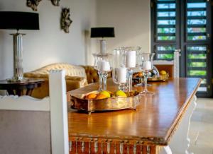 a table with glasses and a bowl of fruit on it at Elia Vama Veche (Adults Only) in Vama Veche