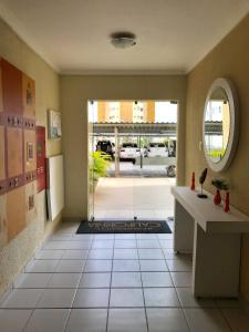 a hallway with a door leading to a patio at Vale Hospedar Califórnia Apart in Petrolina