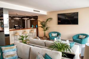 a lobby with couches and chairs and a bar at ABC Hotel Porto - Boavista in Porto