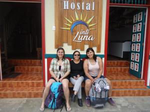 three women posing for a picture in front of a store at IntiLuna Hostel in Salento