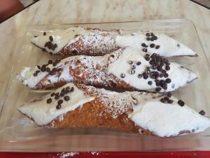 a plate of pastries with cream and chocolate sprinkles at Sole Mare Sale in Torre Nubia