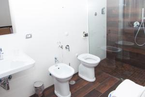a bathroom with a toilet and a sink and a shower at Casa Restino in Torre del Greco