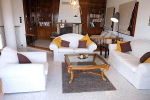 a living room with white couches and a coffee table at Villa Sofia in Marathos