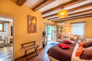 a bedroom with two beds and a living room at Moulin de Vigonac in Brantôme