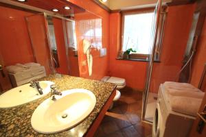 a bathroom with a sink and a shower and a toilet at Casa Elisa in Pozza di Fassa