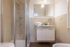 a bathroom with a shower and a sink and a toilet at Palazzo Vecchio Apartments by Mmega in Florence +25 photos