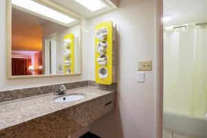 a bathroom with a sink and a mirror at River City Hotel in Decatur