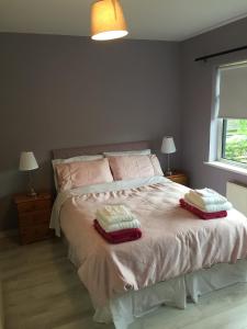 a bedroom with a bed with two pillows on it at Clarendon in Tallaght