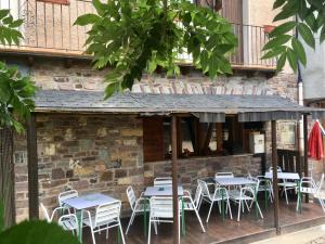 a group of tables and chairs in front of a building at Casa Francho in Laspaúles