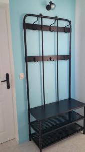 a black shelf in a room next to a door at La Chaumette in Les Sables-dʼOlonne