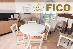 a white table and chairs in a room at Borgo in Chianni in Chianni
