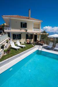 a villa with a swimming pool in front of a house at Villa Amolena in Kariá