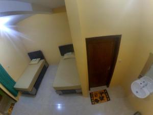 a bathroom with two benches and a toilet at Nitha Homestay Near Train Station in Banyuwangi