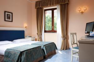 Posteľ alebo postele v izbe v ubytovaní Hotel Iaccarino