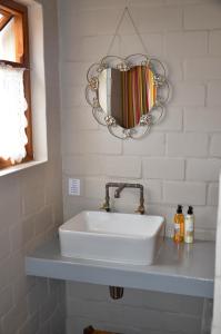 a white sink in a bathroom with a mirror at The Stables in Langebaan