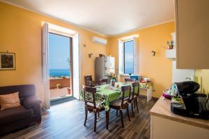 a kitchen and dining room with a table and chairs at Alla Chiazzetta Calabria in Amantea