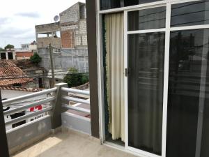 a balcony with a sliding glass door at Hotel Central ParQ in Tonalá