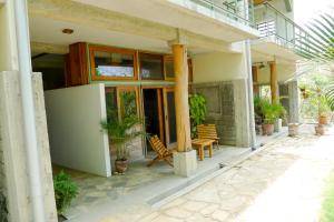uma casa com um alpendre com cadeiras e plantas em Beautiful Studio Suite with Pool - Short walk to Beach em San Juan del Sur