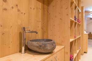 a bathroom with a stone sink on a counter at Quality Hosts Arlberg - Haus Pepi Eiter in Sankt Anton am Arlberg