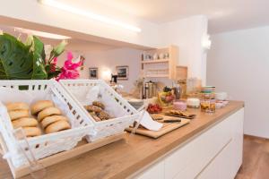 a kitchen with a counter with a bunch of food at Quality Hosts Arlberg - Haus Pepi Eiter in Sankt Anton am Arlberg