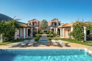 a villa with a swimming pool and a house at Aktes villas in Vasiliki