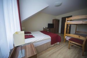 a bedroom with a bed and a bunk bed at Villa Maritima in Grzybowo