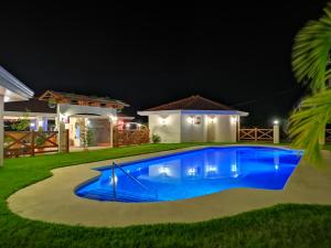 a swimming pool in a yard at night at Pocri Country Resort in Aguadulce +19 photos