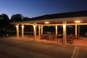 a pavilion with tables and chairs at night at Pocri Country Resort in Aguadulce