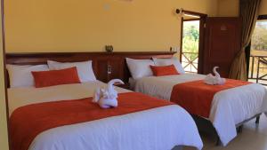 a bedroom with two beds with stuffed animals on them at Pocri Country Resort in Aguadulce