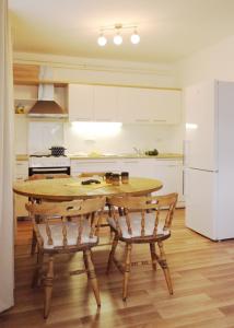 a kitchen with a wooden table and two chairs at Apartment Vista in Tolmin +11 photos