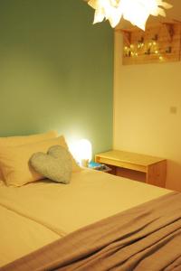 a bed with a heart shaped pillow on it at Apartment Vista in Tolmin