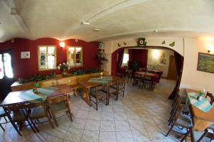 a restaurant with tables and chairs in a room at Penzion Kamenný Dvůr in Vimperk