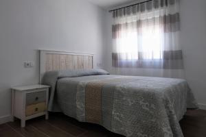 a bedroom with a bed and a window at El Ventanal de Almagro in Almagro