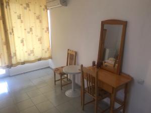 a dining room with a mirror and a table and chairs at Guesthouse in Chernomorets next to Gradina and Sozopol in Chernomorets