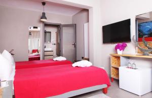 a bedroom with a red bed and a tv at Pitahaya Mutfak in Golturkbuku