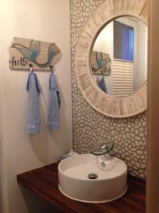 a bathroom with a sink and a mirror at Haus Marianne in Breege