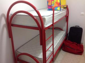 a red bunk bed in a room at Appartamento al mare Puglia in Ginosa Marina