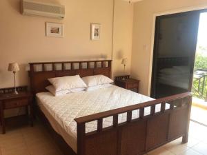 a bedroom with a large bed with two night stands at Limni Pool House B in Larnaca +3 photos