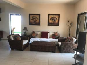 a living room with a couch and two chairs at Limni Pool House B in Larnaca