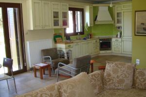 a kitchen with a couch and chairs in a room at Villa Elva in Asprovalta
