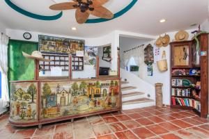 a room with a ceiling fan and a book shelf at Matan Kaan by GuruHotel in Mahahual