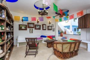 a living room with a table and chairs at Matan Kaan by GuruHotel in Mahahual