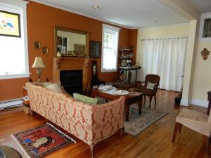 a living room with a couch and a table at Serendipity B&B in North Hatley