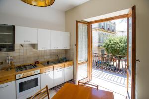 a kitchen with a table and a view of a balcony at Residence Villa Savoia in Marino