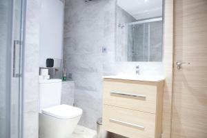 a bathroom with a toilet and a sink and a shower at NEW LOFT ATOCHA Centre in Madrid