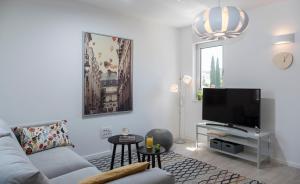 a living room with a couch and a flat screen tv at Paulina in Dubrovnik